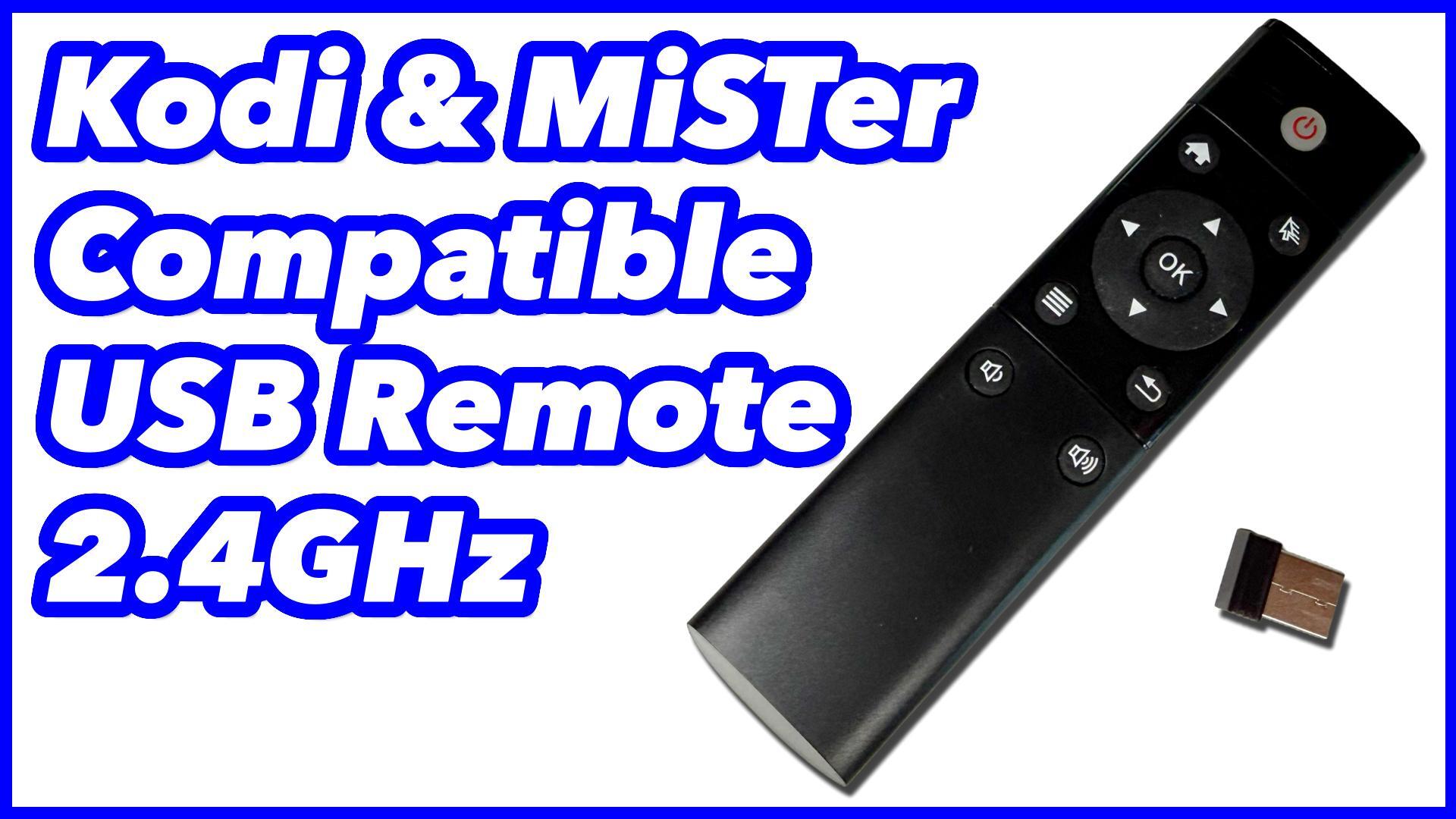 A small minimalist USB wireless remote placed next to a retro gaming setup.